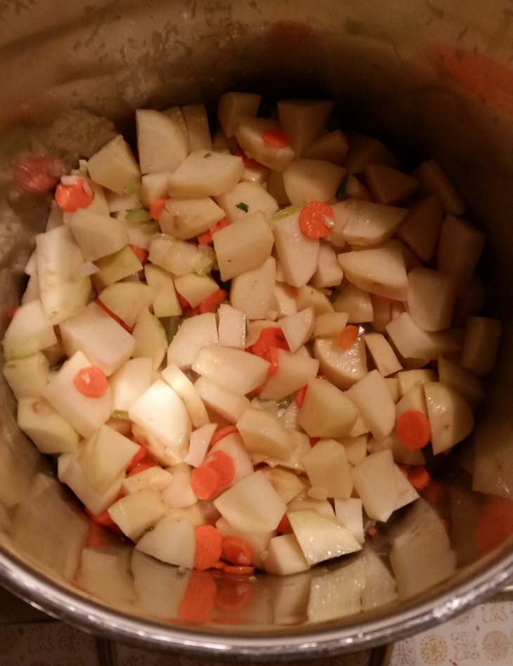 Add potatoes and carrots to the pot.